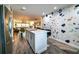 Open kitchen featuring a stylish island, stainless steel refrigerator, and a decorative accent wall at 3850 13 N Ave # 113, St Petersburg, FL 33713