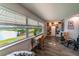 Bright living space with expansive windows overlooking a serene lake and lush greenery at 3850 13 N Ave # 113, St Petersburg, FL 33713