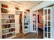 Bright living room area featuring built-in shelves and french doors leading to the bedroom at 3850 13 N Ave # 113, St Petersburg, FL 33713