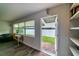 Bright living room with water views, desk, hardwood floors, and access to a brick patio at 3850 13 N Ave # 113, St Petersburg, FL 33713
