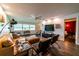 Cozy living room with leather furniture, ceiling fan, and view to adjacent bedroom at 3850 13 N Ave # 113, St Petersburg, FL 33713
