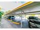 Covered parking area with a line of cars and yellow bumper blocks at 3850 13 N Ave # 113, St Petersburg, FL 33713
