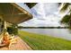 Outdoor patio with red brick and lawn views of the water and community landscape under an awning at 3850 13 N Ave # 113, St Petersburg, FL 33713