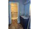 Bathroom featuring a shower with accessible handrail, a dark-stained vanity, and tile flooring at 3902 Shoreside Cir, Tampa, FL 33624