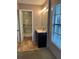 Bathroom featuring a shower with accessible handrail, a dark-stained vanity, and tile flooring at 3902 Shoreside Cir, Tampa, FL 33624