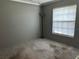 Bright bedroom featuring a large window providing ample natural light at 3902 Shoreside Cir, Tampa, FL 33624