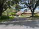 Charming single-story home with stone accents, two-car garage and mature trees at 3902 Shoreside Cir, Tampa, FL 33624