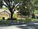 Street view of home exteriors with garages, mature landscaping, and manicured lawns in the community at 3902 Shoreside Cir, Tampa, FL 33624