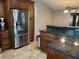Kitchen featuring stainless steel refrigerator, custom cabinets, tile floors and granite countertops at 3902 Shoreside Cir, Tampa, FL 33624