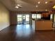 Spacious living room with hardwood flooring, ceiling fan, large sliding doors and breakfast bar at 3902 Shoreside Cir, Tampa, FL 33624