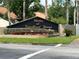 Community entrance sign 'Clusters at Carrollwood Springs' amidst vibrant landscaping and manicured lawns at 3902 Shoreside Cir, Tampa, FL 33624