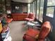 View of sunroom with multiple seating options with a view of a small lake at 3902 Shoreside Cir, Tampa, FL 33624
