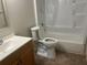 Bright bathroom with a shower-tub combo, toilet, and a single sink vanity with wood cabinets at 4008 Ashford Green Pl # F101, Tampa, FL 33613