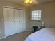 Bedroom with a double bed, ceiling fan, window, and a closet with bi-fold doors at 4008 Ashford Green Pl # F101, Tampa, FL 33613