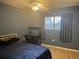 Comfortable bedroom with wood-look floors, desk, and window offering natural light at 4008 Ashford Green Pl # F101, Tampa, FL 33613
