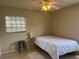 Cozy bedroom with a ceiling fan, window, and a double bed with white linens at 4008 Ashford Green Pl # F101, Tampa, FL 33613