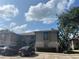 Inviting condo complex with well-maintained grounds, mature trees, and designated parking spaces at 4008 Ashford Green Pl # F101, Tampa, FL 33613