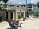 Building exterior with a covered outdoor seating area and views of lush landscaping at 4008 Ashford Green Pl # F101, Tampa, FL 33613