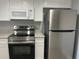 Close-up view of the updated kitchen with stainless steel appliances and light countertops at 4008 Ashford Green Pl # F101, Tampa, FL 33613