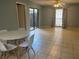 Open living room featuring tile floors, a ceiling fan, and a sliding glass door to a private patio at 4008 Ashford Green Pl # F101, Tampa, FL 33613
