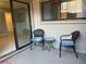 Outdoor patio featuring two chairs and a small table with access through sliding glass doors at 4008 Ashford Green Pl # F101, Tampa, FL 33613