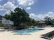 Community pool with lounge chairs and gazebo, perfect for relaxing on sunny days at 4008 Ashford Green Pl # F101, Tampa, FL 33613