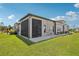 Beautiful backyard showcasing a screened-in lanai with an expansive green lawn perfect for outdoor relaxation at 4325 Barletta Ct, Wesley Chapel, FL 33543