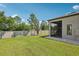 Expansive backyard featuring lush green grass, privacy fence and screened-in lanai for outdoor living and entertaining at 4325 Barletta Ct, Wesley Chapel, FL 33543