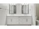 Bright bathroom featuring double vanity sinks with sleek fixtures and ample cabinet space for storage at 4325 Barletta Ct, Wesley Chapel, FL 33543