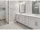 Bathroom with double vanity, large mirror, and walk-in closet at 4325 Barletta Ct, Wesley Chapel, FL 33543