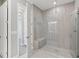Contemporary bathroom showcasing a glass-door shower and a view into the doorway at 4325 Barletta Ct, Wesley Chapel, FL 33543