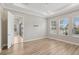Bedroom with wood floors, tray ceiling, and natural light from the windows at 4325 Barletta Ct, Wesley Chapel, FL 33543