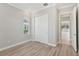 Bedroom with wood flooring, closet, and doorway leading to another room at 4325 Barletta Ct, Wesley Chapel, FL 33543