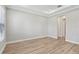 Large bedroom with tray ceiling, wood flooring, and neutral color palette at 4325 Barletta Ct, Wesley Chapel, FL 33543