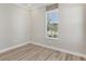 Bedroom with wood flooring and window with blind at 4325 Barletta Ct, Wesley Chapel, FL 33543