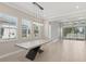 Bright dining room featuring large windows, modern lighting fixture, and a unique, concrete dining table at 4325 Barletta Ct, Wesley Chapel, FL 33543