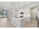 Open-concept kitchen featuring an island, stainless steel appliances, and modern pendant lighting at 4325 Barletta Ct, Wesley Chapel, FL 33543
