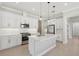 Well-equipped kitchen with white cabinets, island, stainless steel appliances, and modern finishes at 4325 Barletta Ct, Wesley Chapel, FL 33543