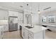 Spacious kitchen with stainless steel appliances, white cabinets and a view into the dining area at 4325 Barletta Ct, Wesley Chapel, FL 33543
