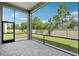 Screened-in lanai offers a comfortable outdoor space, looking out onto a well-maintained backyard and lush greenery at 4325 Barletta Ct, Wesley Chapel, FL 33543