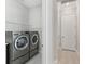 Bright laundry room featuring modern appliances at 4325 Barletta Ct, Wesley Chapel, FL 33543