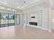 Bright living room with large sliding glass door and modern electric fireplace at 4325 Barletta Ct, Wesley Chapel, FL 33543
