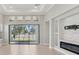 Bright living room with a large sliding glass door and modern recessed lighting at 4325 Barletta Ct, Wesley Chapel, FL 33543