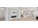 Spacious living room with modern fireplace feature, open to the kitchen area at 4325 Barletta Ct, Wesley Chapel, FL 33543