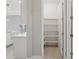 Walk-in pantry with white shelving and door next to the kitchen at 4325 Barletta Ct, Wesley Chapel, FL 33543