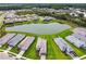 Panoramic aerial view of a serene community surrounding a central pond at 4709 Isonzo Way, Wesley Chapel, FL 33543