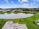Aerial view of a beautiful neighborhood with pond and lush trees at 4709 Isonzo Way, Wesley Chapel, FL 33543