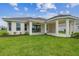 A spacious backyard featuring a covered patio with white columns at 4709 Isonzo Way, Wesley Chapel, FL 33543