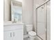 A bathroom featuring a single sink vanity, quartz countertop, and a glass enclosed shower at 4709 Isonzo Way, Wesley Chapel, FL 33543