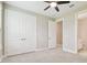 This bedroom has neutral colors and has large closet doors and a ceiling fan at 4709 Isonzo Way, Wesley Chapel, FL 33543